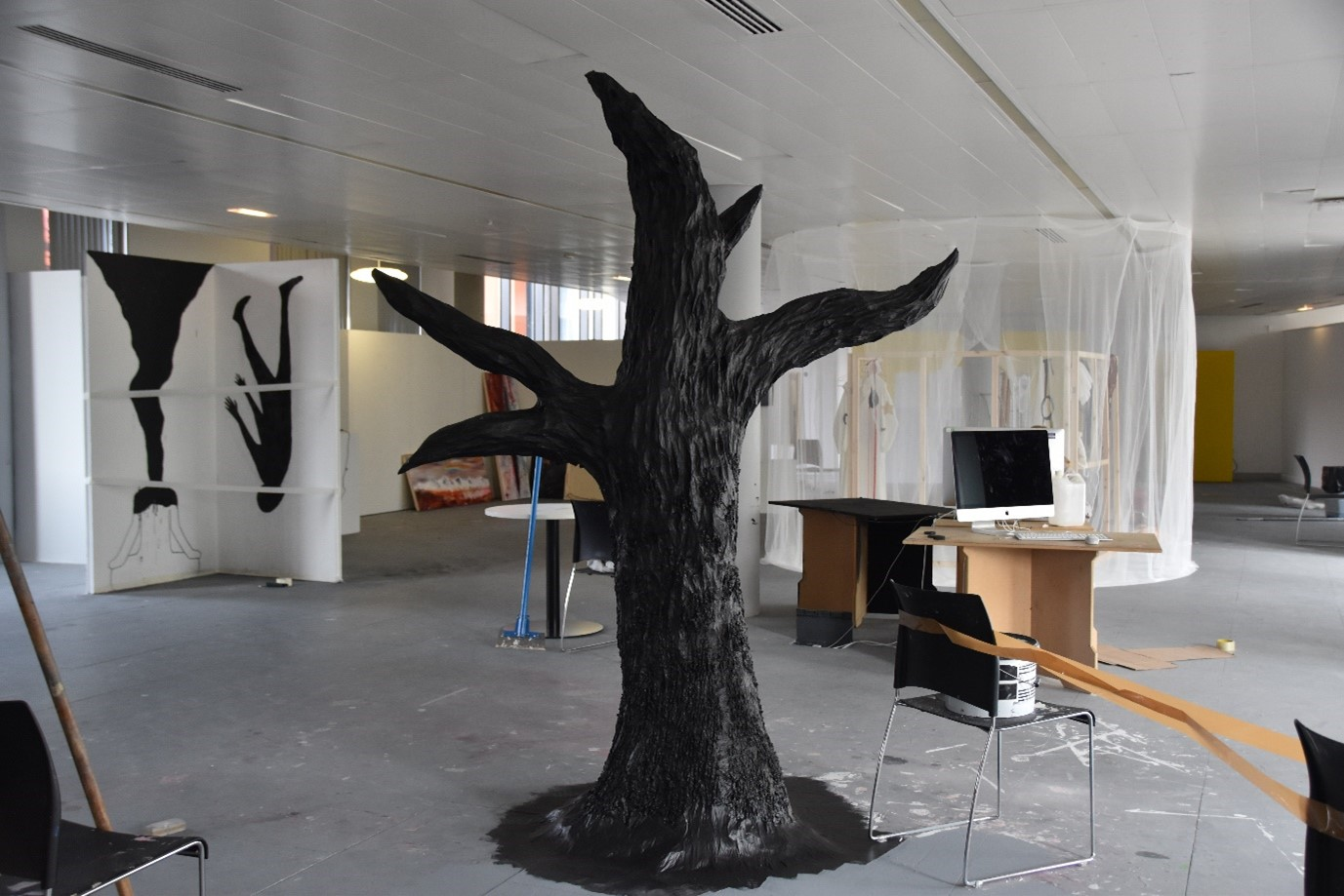 A model of a black tree made from wood, chicken wire, paper-mâché, acrylic paint